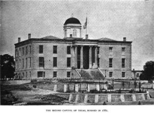 A black and white photograph of the Texas State Capitol building