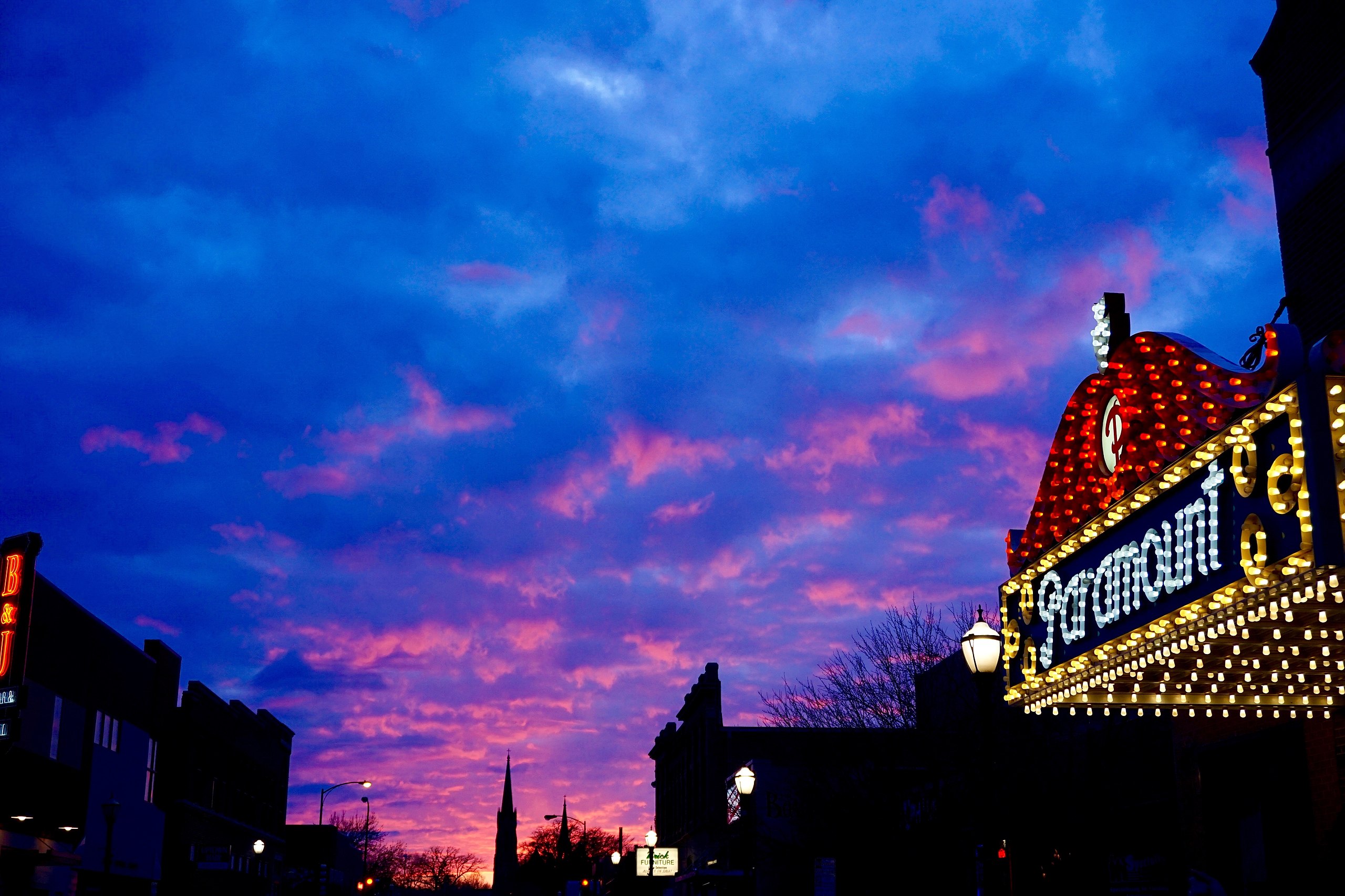 The entrance to the paramount theatre under a purple sunset